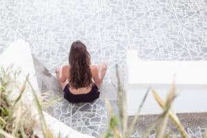 woman meditating poolside