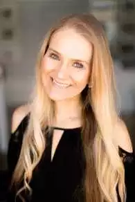 Christine Schroeter headshot showing her with long blonde hair smiling for the camera.