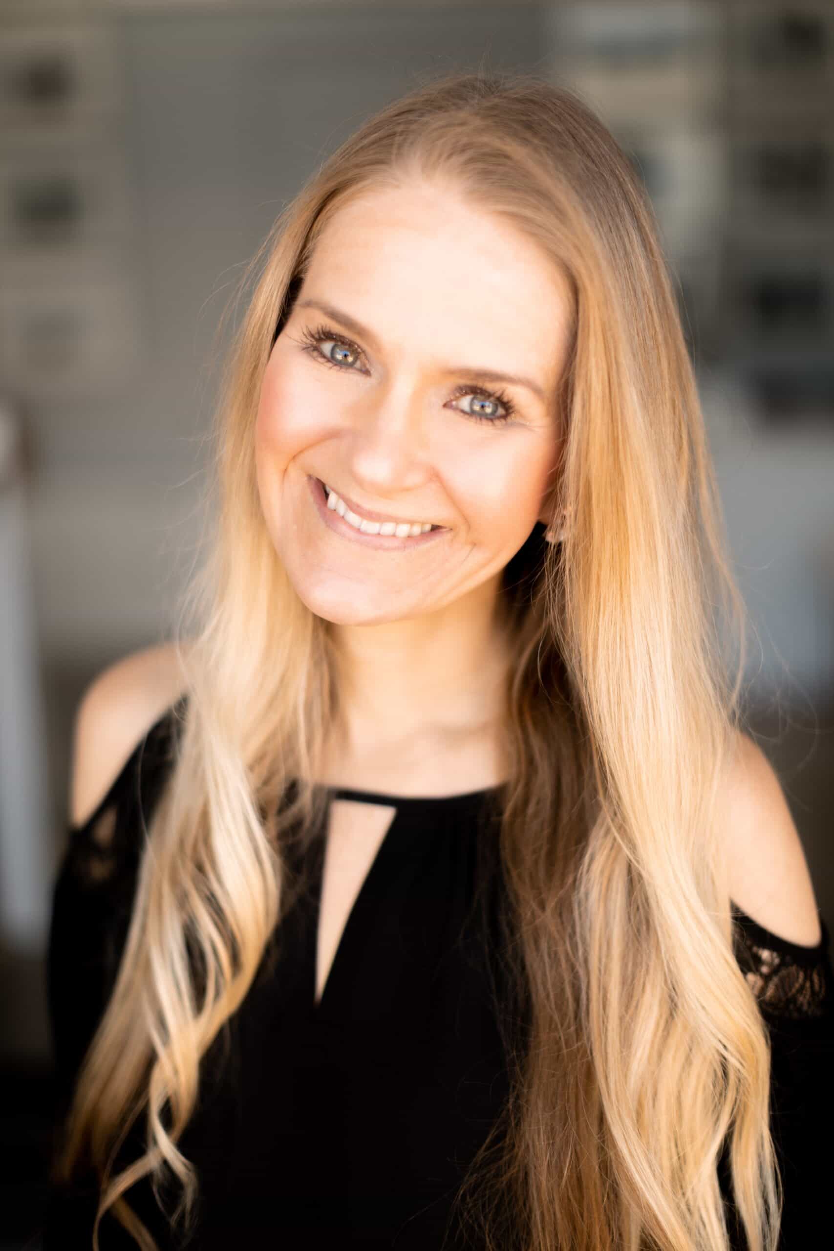 Christine Schroeter headshot showing her with long blonde hair smiling for the camera.