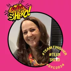 A smiling woman featured within a pink circular frame, with superhero-themed graphics and text overlays such as "super shero!", "#teamfinisher #teamsheno #syc2024.